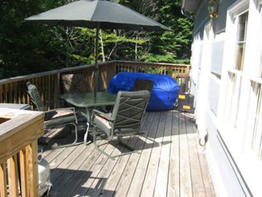 Deck with deck furniture, grill, hot tub. Great for cookouts - relaxing and lounging enjoying the woods surrounding this tourist home.