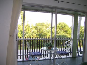 Screened in lanai overlooks tropical nature sanctuary