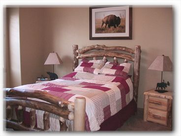 Master bedroom with rustic log bed