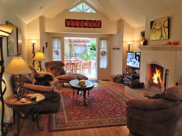 Relax in the great room with raised ceilings and gas/wood burning fireplace.	