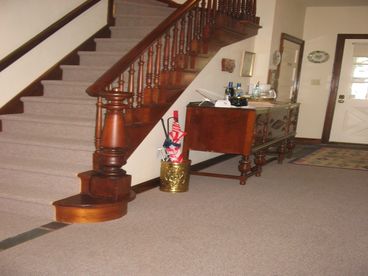 Private foyer with beautiful walnut staircase to the Sunroom .