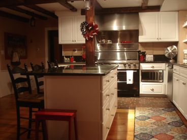 The renovated kitchen features granite countertops and Professional Viking Range.  Skylights allow lots of light and the large island makes it a great place to gather friends and family.