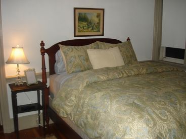 This comfortable guest room is the only one on the first floor and has a private bathroom with a tub/shower combination.  The bed is a queen size with a very high, pillowtop mattress and features luxury linens.  The room also has a small TV with satellite cable.