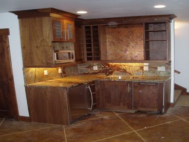 lower level wet bar with micro, u line refridge with ice maker and a bosch dishwasher,  lower level has large flat screen and bumper/ poker table
