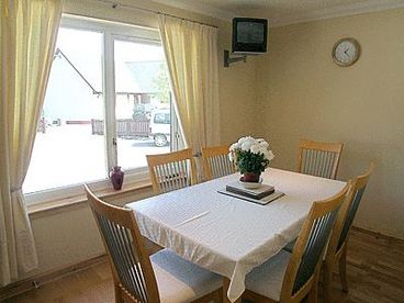 Within the Dining room area, there is comfortable seating for 6 persons, as well as a breakfast bar, where you can relax and socialise with others.  There is also a private television.