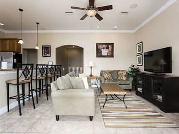The second floor living room, beautifully outfitted with comfy chairs and love-seats, has a 37\