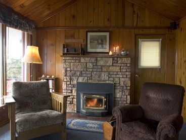 Knotty pine living room with wood fireplace
