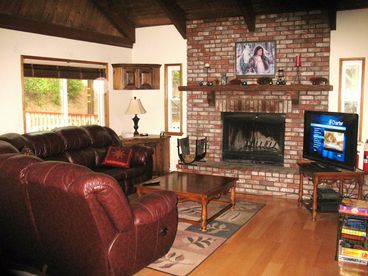 Beautiful living room with fireplace and large screen television.