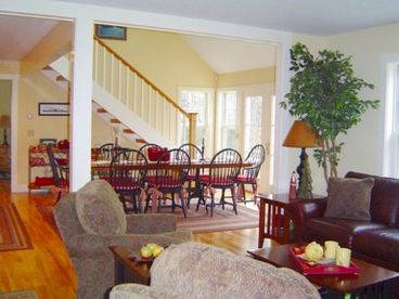 Dining Area opens to living area with fireplace and overlooks swimming pond with mountain views