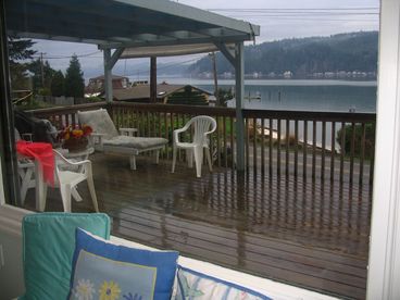 View of Hood Canal and the Olympic Mountains from the kitchen looking out at the covered eating deck!