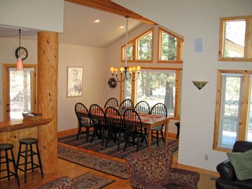 Spacious dining room seats 12 with additonal seating for 5 at hand-hewn log eating bar