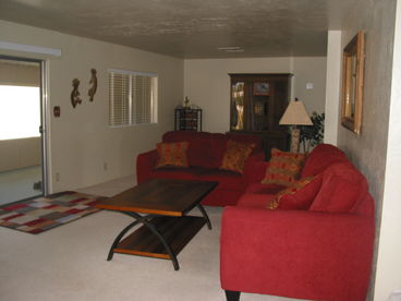 View of living room and screen door to the Arizona room, which is longer than the living room.