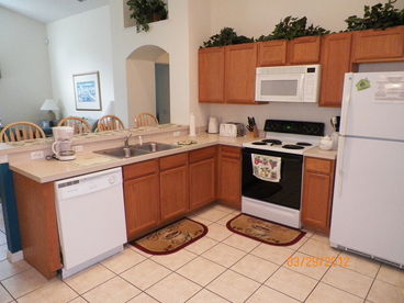 Fully equipped kitchen with electric range, dishwasher, garbage disposal, electric tea kettle