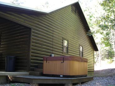 View of the back of the house and the hot tub.