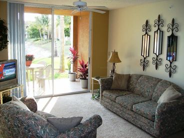 Enjoy the livingroom while appreciating the tropical views on the lanai and lake. 