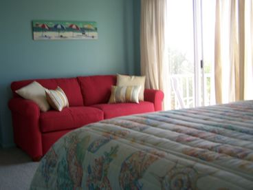 2nd bedroom with double sleeper sofa, with a balcony, linens, towels, and beach towels provided