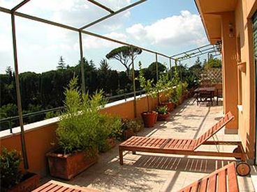 1st of two terraces of 100 m2, furnished with table, chairs, deckchairs and sun beds
