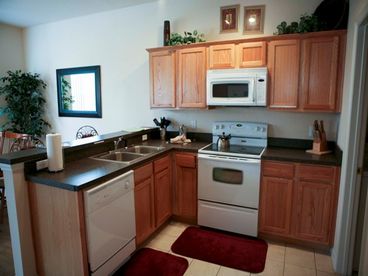 Fully Equipped Kitchen with a breafast area and bar.