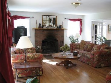 The Large Living Room features a 12 foot Slider to the Deck, French Doors to the Office, Extremely Comfortable Overstuffed Furniture and an inviting Wood Burning Fireplace.