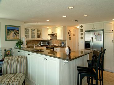 Stainless steel appliances, gas dual fuel range, granite counters, stone floors and back splash.