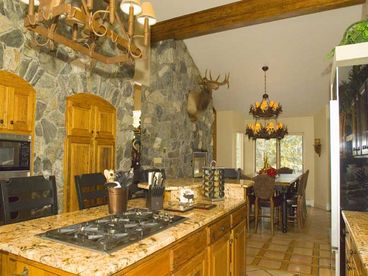 Well equipped gourmet kitchen has polished granite countertops, 6 burner gas stove, wormy cedar custom cabinets. Dining room has two high tables, fabulous mountain chandelier, fireplace, and ski area views.