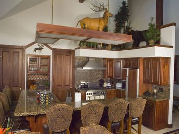 Beautiful, fully-equipped gourmet kitchen has polished granite counter tops, walk in pantry, bar, 2nd oven, 6 burner viking stove & views of ten mile range!