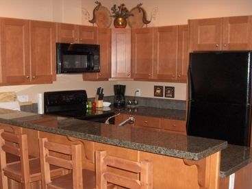 Kitchen with eating counter & stools