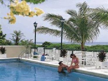 Scenic pool (heated in winter) area overlooking beach w tables, padded lounge chairs,  dining table and BBQ. Enjoy a great meal/setting. Workout room adjacent to pool area