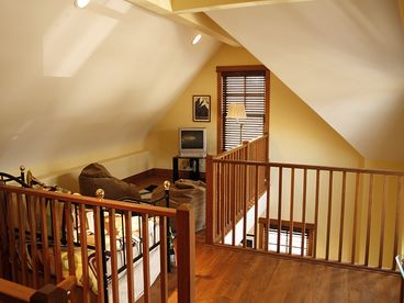 Loft with bean bags, twin bed with trundle and tv with dvd.