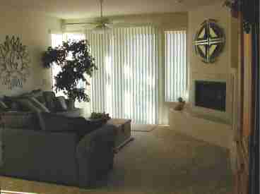Living Room with Fireplace.  Exit the sliding glass door onto the large private patio.