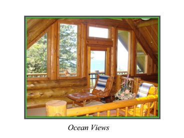 This picture shows the magnificent framework of this cabin.  There is a balcony just outside the door with ocean views galore. 