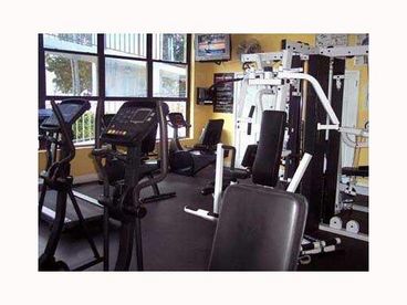 Fully equipped fitness center with a sauna and bath house with a view of the beautifully manicured grounds