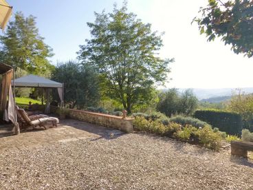 Private terrace with a view over Tuscan hills.