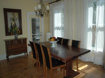 High vaulted ceilings and abundance of windows allow for wonderful sunlight and a beautiful view to the garden from the dining room. 