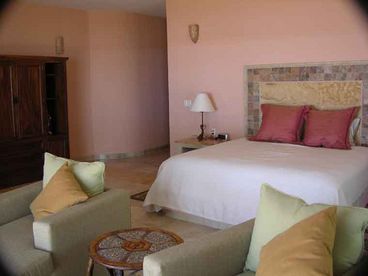 Spacious master bedroom suite with king bed, large bath, and spectacular view to the beach
