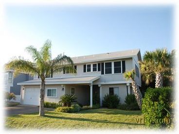 Lovely canal front home w/lush landscaping.