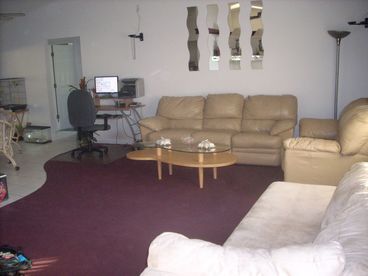 Modern living area (Couches, coffee table, tv stand and 36 inch TV).