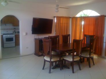 55 inch flat screen in a nature light open dining and living room