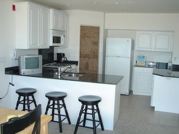 Fully equipped gourmet kitchen with granite countertop. 