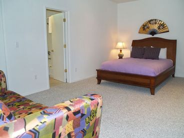 Master bedroom with Queen size bed, sofa sleeper, and adjoining bathroom. 
