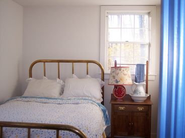 Full size antique brass bed, oask wash stand and antique dress. The bedroom overlooks the mountains to the east.