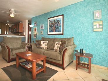  living room with a queen size sofa bed, 32 inch lcd tv, cable tv, cd/dvd players, beach view balcony.
