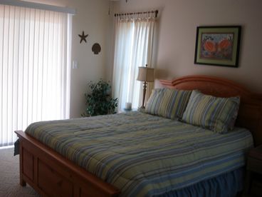 1st floor bedroom with queen bed; opens onto covered porch