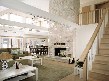 Soaring cathedral ceiling, white marble fireplace, comfortable seating for 12.