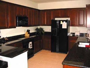 Feel like cooking at home? Plenty of space to entertain, granite countertops, cherry cabinets, breakfast bar for those on the run!