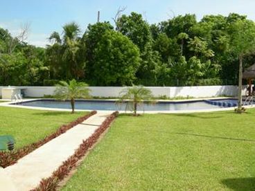 swimming pool backed by the Playacar bird sanctuary