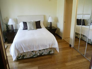 Bedroom with large flatscreen TV/DVD and queen bed with 500 thread-count linens