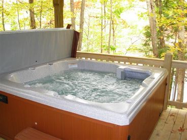 Hot tub on lower deck overlooking lake. 