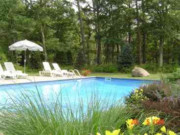 Lovely pool surrounded by gardens, lawn and preserve land.