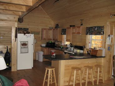 Fully equipped kitchen with extra seating. We have all the appliances you would find in your own  kitchen at home and then some.